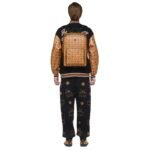 The MCM Medium Aren Backpack in Visetos Cognac embodies contemporary elegance with its sleek rectangular silhouette, designed to accommodate essential tech gadgets like laptops, tablets, and documents. Crafted for the modern individual, this backpack seamlessly merges functionality with timeless style, boasting a soft microfiber suede interior that provides a luxurious backdrop for your belongings. Measuring approximately 5.1 x 12.2 x 16.5 inches, this backpack offers ample storage space while maintaining a streamlined profile. Its adjustable logo-woven shoulder straps ensure a comfortable fit, allowing you to carry your essentials with ease throughout the day. Additionally, a leather top handle provides versatility in carrying options, whether you prefer to sling it over your shoulders or hold it by hand. At the forefront of the design is MCM's commitment to quality craftsmanship, evident in the meticulous construction from signature Visetos monogram canvas and premium nappa leather. The Visetos monogram, an iconic symbol of the brand, adorns the exterior, exuding sophistication and style. Nappa leather trim accents add a touch of refinement, enhancing the backpack's overall aesthetic appeal. Practical features such as a front zip pocket and interior slip pocket offer convenient storage for smaller items, keeping them easily accessible when you're on the go. The two-way zip closure ensures secure closure, safeguarding your belongings while providing effortless access. Comfort is prioritized with a padded back panel, providing cushioning and support for extended wear. Matte black metal hardware adds a modern edge to the design, complementing the rich tones of the Visetos monogram and nappa leather trim. Designed and crafted in South Korea, this backpack exemplifies MCM's commitment to quality and innovation. Its fusion of modern utility and heritage craftsmanship makes it an essential accessory for the contemporary individual seeking both style and functionality in their everyday carry. Whether for work, travel, or leisure, the MCM Medium Aren Backpack is a versatile companion that effortlessly elevates any ensemble.