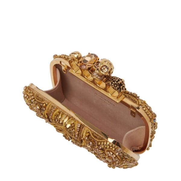 Alexander McQueen Women's knuckle clutch in gold.