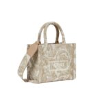 The Versace Barocco Athena Extra Small Tote Bag is an exquisite fusion of opulence, sophistication, and timeless elegance. Crafted with meticulous attention to detail, this iconic piece encapsulates the essence of the Versace brand, showcasing its signature Barocco motif and distinctive design elements. At first glance, the bag exudes a sense of luxury, boasting a striking combination of rich textures and vibrant hues. The Barocco motif, synonymous with Versace's heritage, adorns the exterior of the bag, intricately woven into the fabric with precision and finesse. Its bold and intricate patterns pay homage to classical Greek and Roman art, adding a touch of regal grandeur to the design. Constructed from premium materials of the highest quality, the tote bag is both durable and luxurious. The supple leather exterior is soft to the touch, while the gleaming gold-tone hardware adds a touch of glamour and refinement. The structured silhouette maintains its shape effortlessly, exuding an air of sophistication and poise. Practical yet stylish, the Extra Small Tote Bag is designed to cater to the modern woman's lifestyle. Despite its compact size, the interior offers ample space to accommodate essentials such as keys, phone, wallet, and makeup, making it ideal for both day-to-day use and special occasions. The interior is lined with sumptuous satin fabric, providing a luxurious backdrop for your belongings. Versatility is another hallmark of this timeless accessory. Whether carried by the top handles for a polished look or slung over the shoulder using the detachable strap for added convenience, the tote bag effortlessly transitions from day to night, complementing any ensemble with effortless sophistication. In conclusion, the Versace Barocco Athena Extra Small Tote Bag is a true masterpiece that embodies the epitome of luxury and style. With its exquisite craftsmanship, iconic design, and practical functionality, it is more than just a fashion accessory—it is a symbol of prestige, refinement, and enduring elegance.