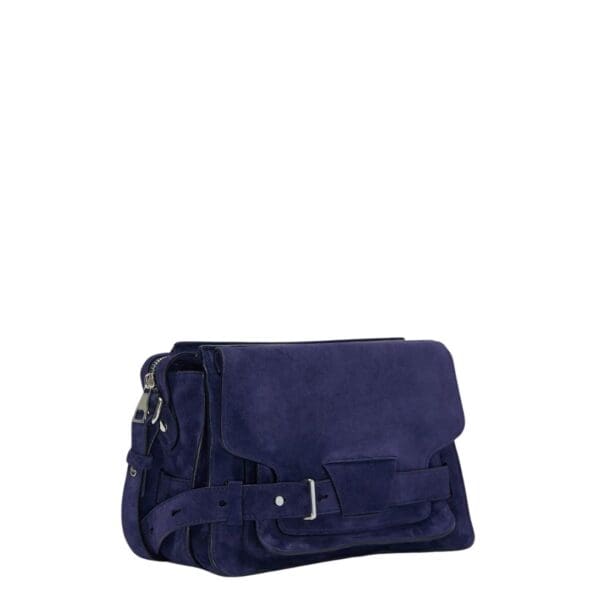 Indulge in understated elegance with the Beacon Saddle Bag in Suede, a captivating creation that pays homage to the rugged charm of traditional workwear satchels. Crafted from sumptuously supple suede in a deep, alluring dark blue hue, this accessory embodies sophistication and refinement while embracing its utilitarian inspiration. The Beacon Saddle Bag in Suede is a testament to the brand's dedication to superior craftsmanship and meticulous attention to detail. The supple suede material lends a luxurious touch to the design, inviting touch and admiration with its velvety texture and rich color. At the forefront of the design are the signature belted straps adorned with a distinguished D-ring buckle, securing the fold-over flap with both practicality and style. Inspired by the functionality of workwear satchels, these straps add a touch of rugged elegance to the bag while ensuring the safety of your belongings. Versatility is key with the adjustable shoulder strap, allowing you to effortlessly transition from day to night with ease and comfort. Whether worn crossbody for hands-free convenience or elegantly draped over the shoulder, this thoughtful addition ensures that the bag complements your every movement with grace and style. Practicality meets sophistication with the inclusion of a zip top fastening, providing secure closure for your essentials, while a zip back pocket offers convenient access to items on the go. Inside, an internal zip pocket further enhances organization, keeping your belongings neatly stowed within the spacious interior. Elevating the bag's aesthetic appeal are silver-tone metal hardware accents, adding a touch of modernity and refinement to its timeless design. From the precise stitching to the polished hardware, each detail is meticulously executed, reflecting the brand's dedication to impeccable craftsmanship and quality. In essence, the Beacon Saddle Bag in Suede epitomizes the perfect blend of classic elegance and contemporary sophistication. With its exquisite craftsmanship, thoughtful design, and enduring appeal, it stands as a testament to the brand's commitment to timeless style and impeccable quality, inviting you to elevate your ensemble with effortless sophistication and grace.