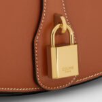 CLUTCH ON STRAP TABOU IN SMOOTH CALFSKIN